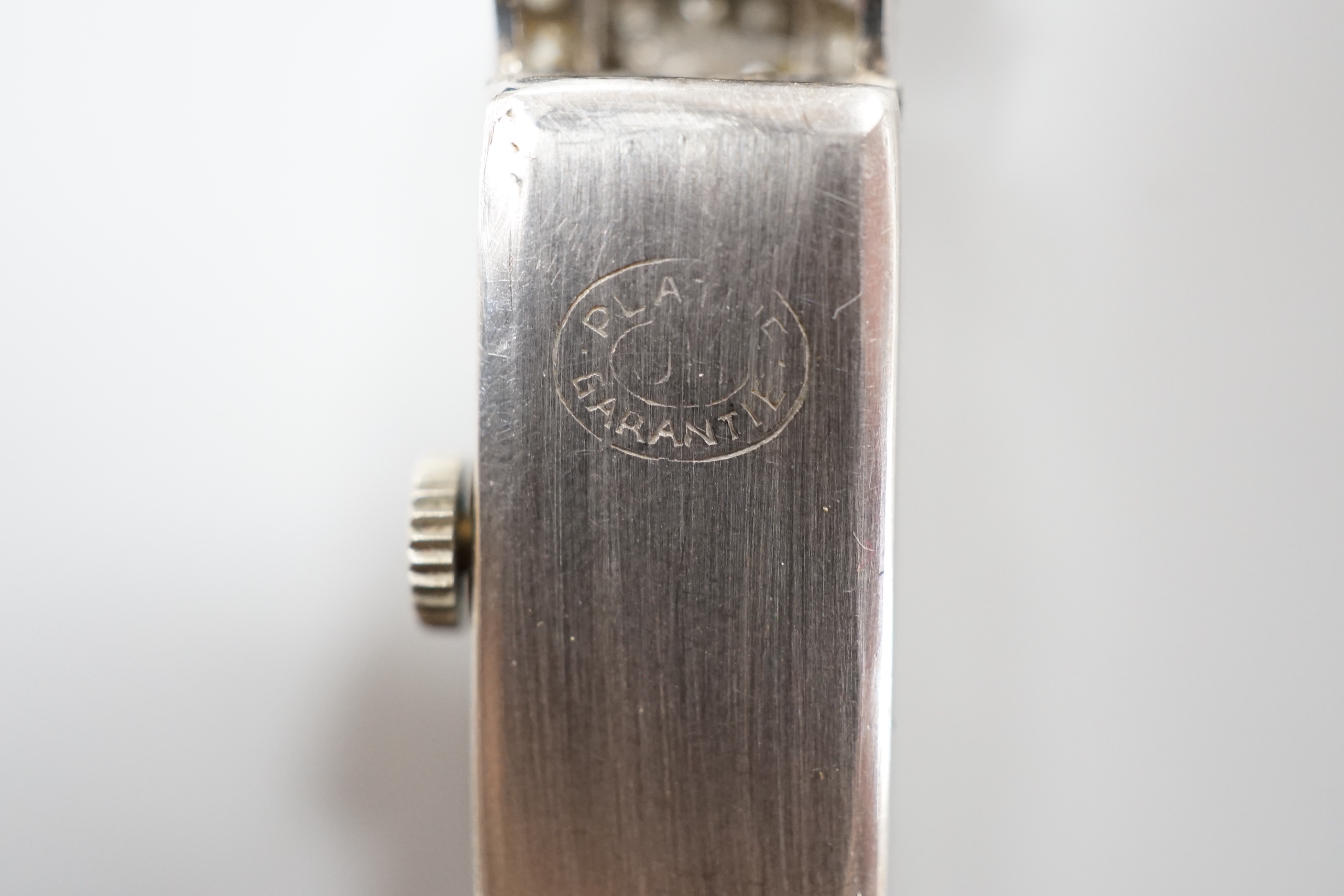 A lady's 1930's/2940's white metal (engraved All Platine) and diamond set manual wind cocktail watch, on a twin fabric strap.
